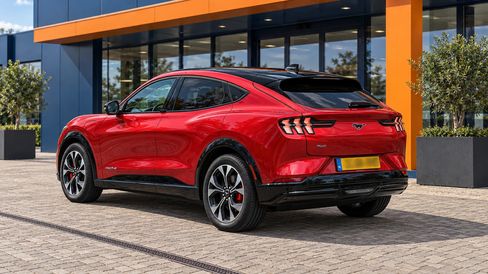 Achterzijde van dezelfde rode Ford Mustang Mach-E AWD