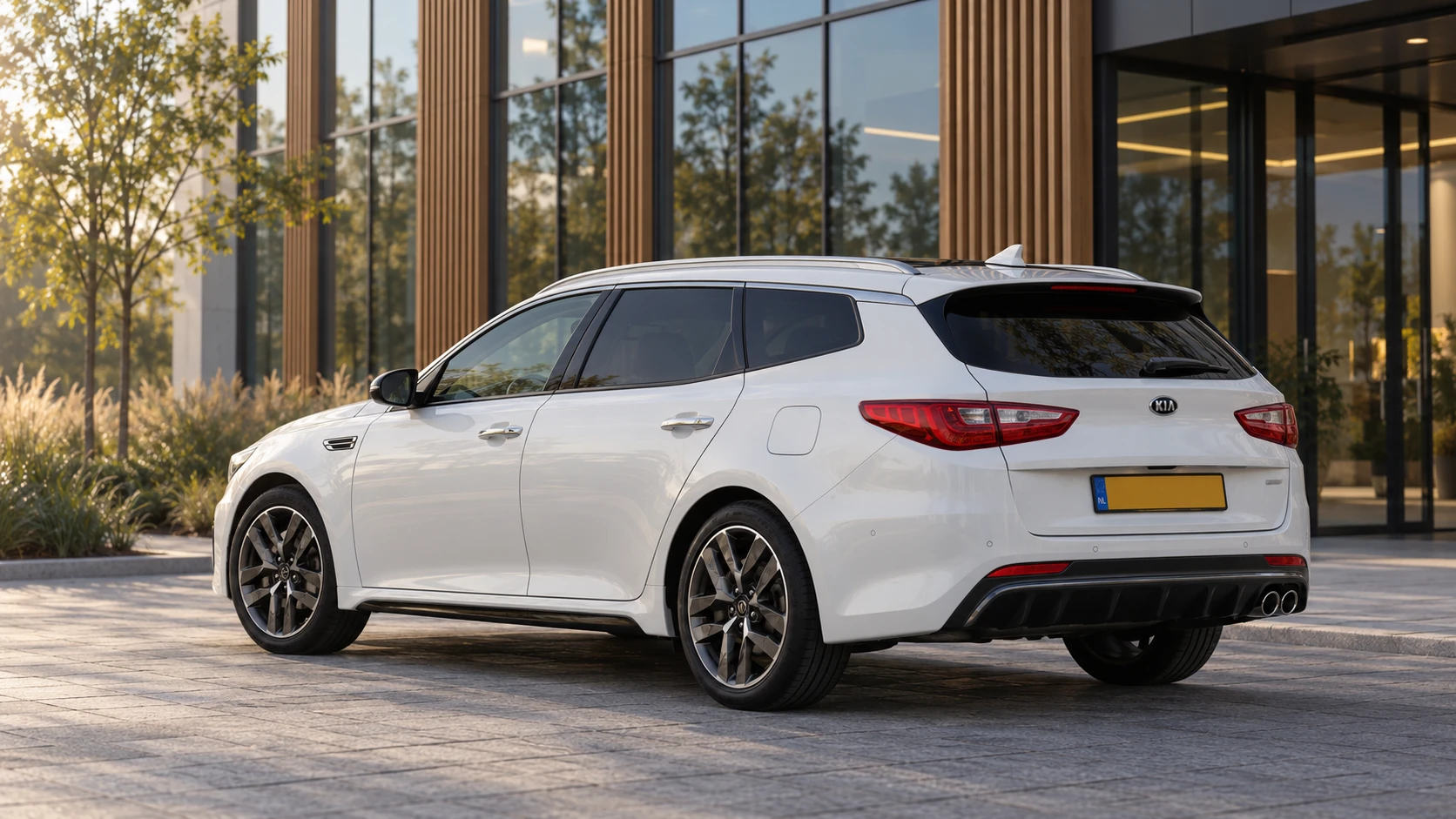 Dezelfde witte Kia Optima Sportswagon, schuin van achteren